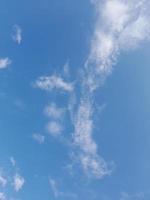 Beautiful white clouds on deep blue sky background. Large bright soft fluffy clouds are cover the entire blue sky. photo