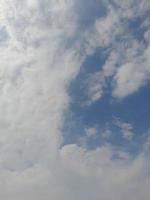 Beautiful white clouds on deep blue sky background. Large bright soft fluffy clouds are cover the entire blue sky. photo