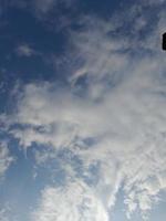 Beautiful white clouds on deep blue sky background. Large bright soft fluffy clouds are cover the entire blue sky. photo