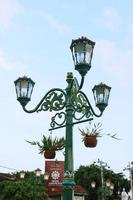 Vintage city lamp with blue sky view and clouds photo