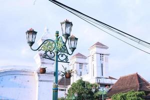 Vintage city lamp with blue sky view and clouds photo