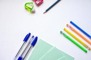 A set of stationery on a white background, pens of different colors photo