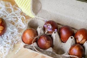 Painted eggs cooked for Easter are in an eco-friendly tray on the table photo
