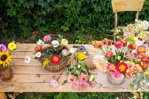 The florist's desk with autumn flowers and tools is on the street photo