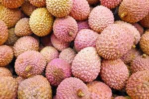 Stack of Lychees on a market stall photo