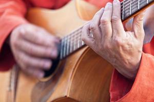 Medieval minstrel playing guitar photo