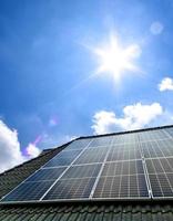 Solar panels producing clean energy on a roof of a residential house photo