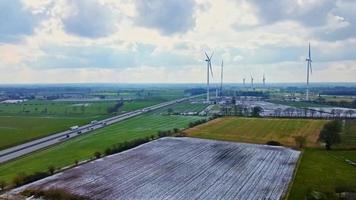 View from above on the German motorway A7 with some windmills for renewable electricity under construction. photo