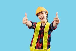 Young female engineer in helmet stand with thumb up posture photo