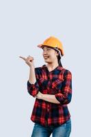 Young asian engineer female standing with point finger posture photo