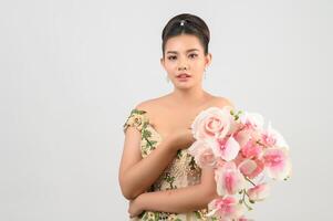 Young asian beautiful bride with orchid bouquet on white background photo