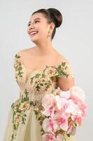 Young asian beautiful bride with orchid bouquet on white background photo