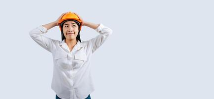 Young female engineer in helmet stand with thoughtful posture photo