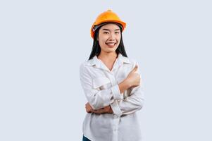 Young female engineer in helmet stand with thumb up posture photo