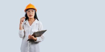 Young female engineer wearing Yellow helmet and safety eyeglasses photo