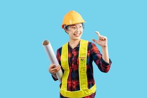 Young female engineer wearing yellow helmet hold blueprint posture photo