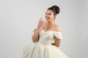 Young asian beautiful bride smiling with happy on white background photo