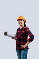 Young female engineer wearing a yellow safety helmet with Blueprints photo