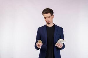 Portrait of Young smiling handsome businessman showing credit card isolated over white background photo