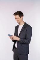 Portrait of a happy businessman using smartphone over white background photo
