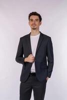 Portrait of happy handsome young man in suit posing on isolated background photo