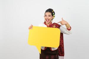 Young beautiful woman in Thai lanna costume with blank speech bubble sign photo