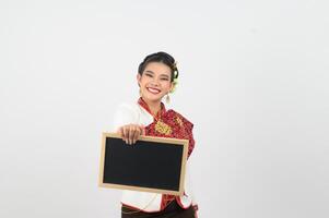 Portrait of Beautiful Thai Woman in Traditional Clothing Posing with blackboard photo