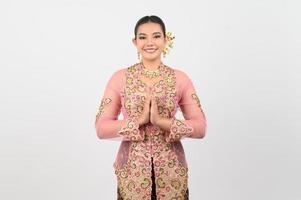 Young beautiful woman dress up in local culture in southern region with salute posture photo