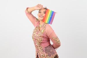 Young beautiful woman dress up in local culture in southern region with rainbow flag photo