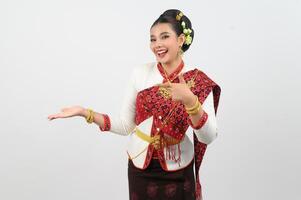 Young beautiful woman in northeastern dress stand and open palm posture photo