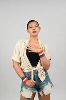 Portrait young asian woman in concept LGBQ with wristband on white background photo