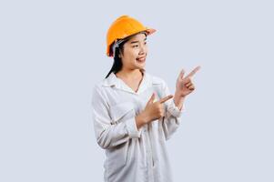 Young asian engineer female standing with point finger posture photo