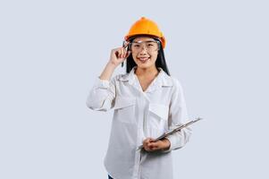Young female engineer wearing Yellow helmet and safety eyeglasses photo