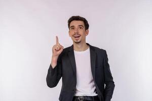 Portrait of happy young businessman having great idea over studio background photo