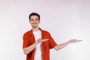 retrato de un joven feliz y sonriente que presenta y muestra su texto o producto aislado de fondo blanco foto