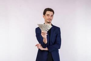 Portrait of a cheerful man holding dollar bills over white background photo
