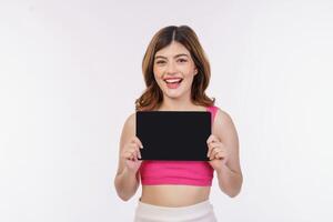 Portrait of excited young woman holding tablet mock up isolated over white background photo