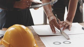 Two business man construction site engineer. Engineering objects on workplace with partners interacting on background video