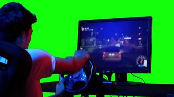 Young man play racing game with green screen. video