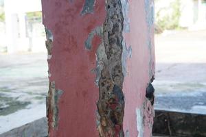 the cement pillar wall is damaged and eroded photo