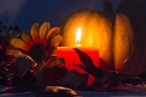 autumn decoration with burning candle in the dark photo