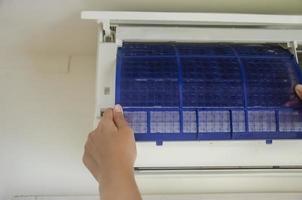 Prepare to clean the air conditioner filter from dust. photo