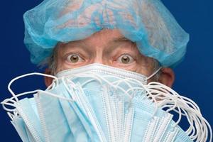 Portrait of senior adult fearful glance in medical face mask covering nose and mouth from SARS, 2019-ncov infection photo