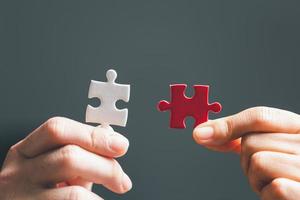 Business woman person hand holding puzzle piece idea for strategy and solution. Closeup part of two jigsaw connect together. Concept of join cooperation success teamwork-problem corporate team photo