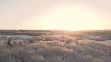 Bird's eye view of paved road over snowy grass fields video