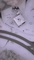 Aerial view of paved road over snowy grass fields video