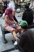 The therapist of Javanese street massage give massage to tourists and traveler photo