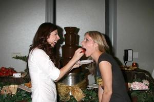 Heather Matarazzo feeding her Fiance Carolyn Murphy a chocolate covered strawberry at  the GBK Same Sex in The City  Wedding Show in Los Angeles CA onAugust 17 20082008 photo