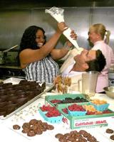Sherri Shepherd and Cameron Mathison in the Wolfgang Puck Catering kitchen demonstrating and trying the deserts for the Daytime Emmy dinner adjacent to the Kodak Theater piror to Daytime Emmys at the Kodak Theater in Hollywood, CA June 19, 2008 photo