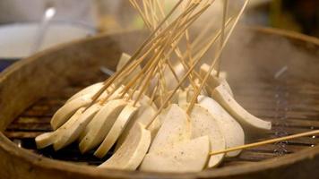 steamed pork with bamboo skewer,street food in Thailand. video